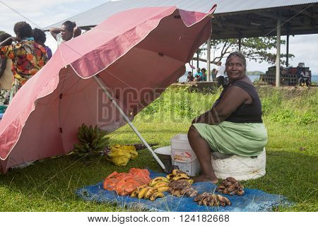Batuna, Solomon Islands - May 28, 2015: Woman selling bananas at the local village market.