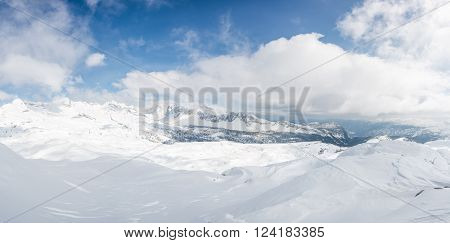 Winter panorama with snow covered slopes and dramatic sky. Komna, Slovenia.
