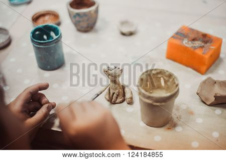 children's hands sculpts clay crafts pottery school