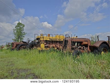 BARNESVILLE, MINNESOTA, June 2, 2014: A Minneapolis Moline tractor in a junkyard is a product of Minneapolis-Moline, a large tractor and machinery producer based in Minnesota. It was the product of a merger between three companies in 1929: