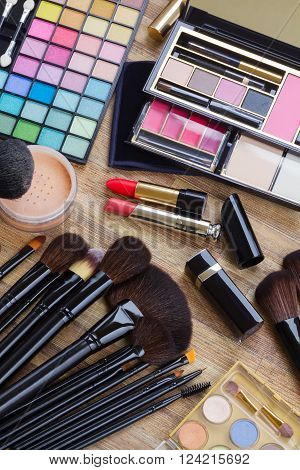 Set of  brushes, lipsticks, maskara, eye shadows and  powder, top view