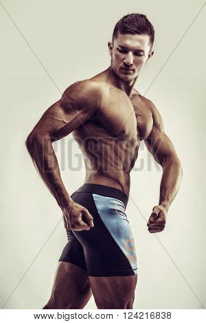 Bodybuilder Man Posing, Showing Perfect Abs, Houlders, Biceps, Triceps, Chest