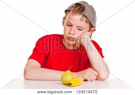 Morose Young Boy Staring At A Ripe Banana And Pear