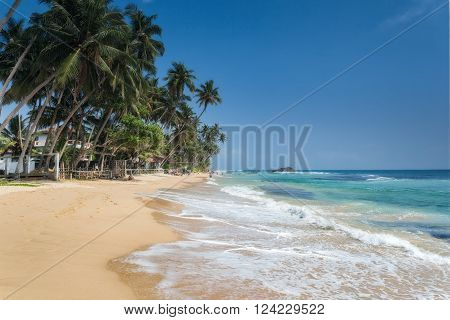 Unidentified people on the beach at Hikkaduwa. Hikkaduwa's beach and night life make it a popular tourist destination.