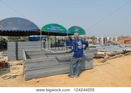 Two Men Workers Hold Iron Frame