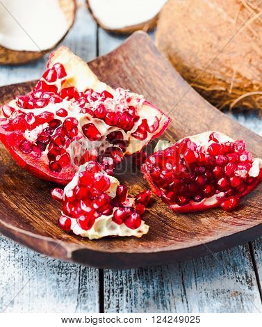 Ripe Red Pomegranate In A Wooden Bowl,blue Background