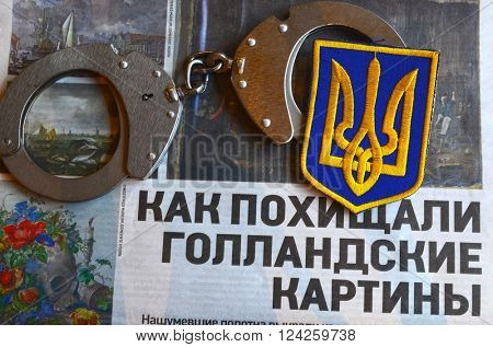 Kiev,Ukraine.FEB 20.ILLUSTRATIVE EDITORIAL.Chevron Ukrainian nazionalist battalion.Background - newspaper about West Frisian Museum stolen art . February 20,2016 in Kiev, Ukraine