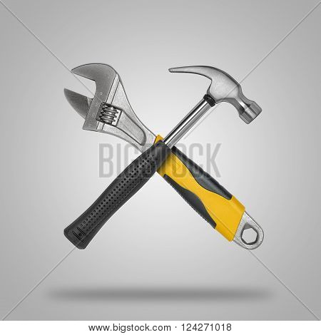 Crossed hammer and wrench. Tools for carpentry work.