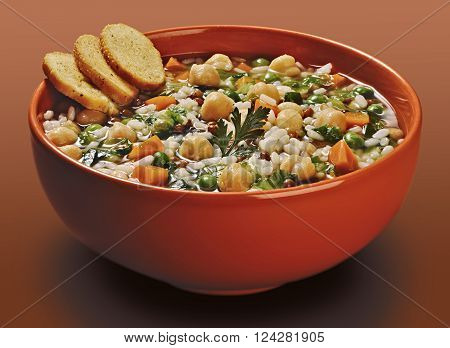 Isolated Orange bowl of rice soup with lentils and peas chickpeas