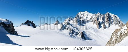 Mont Blanc, France: winter panorama on the east face from Geant Glacier. On the right the pinnacles of Mont Maudit. On the left the upper station of the Skyway cable-car from Courmayer, Italy.