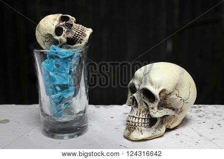 Skull With Blue Ice In Shot Glass. -still Life