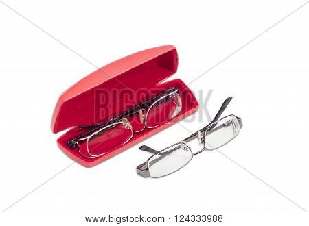 One modern pair of women's eyeglasses in open red spectacle case and one pair of eyeglasses with metal frame beside on a light background