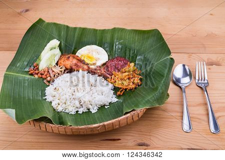 Traditional Nasi Lemak Cuisine On Banana Leaf With Fried Chicken