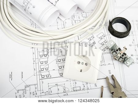 Architecture plan and rolls of blueprints with cabel and plug. Building concept