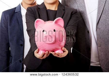 Business team-two men and woman holding piggybank
