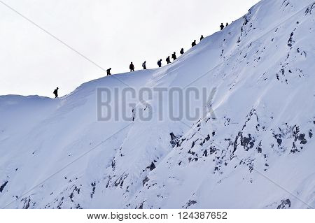 Mountaineers climbing with crampons on Fagaras Mountains ridge Carpathian Range in Romania