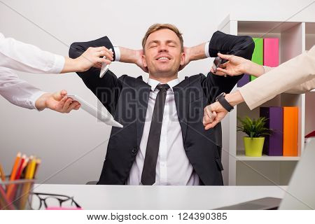 Happy and relaxed man at the office