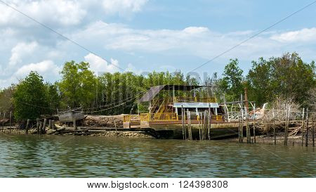 the thai old wooden fishing boat is parking on the beach