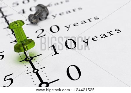 10 years written on a paper with a blue pushpin concept image for business vision or long term prospective. 3D illustration