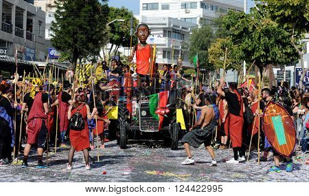 LIMASSOL CYPRUS - MARCH 13 : Happy people in teams dressed with colorful costumes at famous Limassol Carnival Parade on March 13 2016 in Limassol town Cyprus.