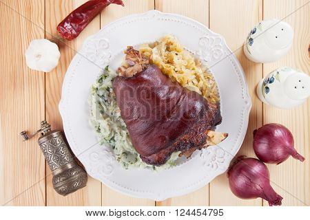 Roasted pork knuckle with sour cabbage and mashed potato
