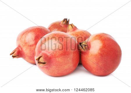 Pile of multiple pomegranate Punica granatum fruits isolated over the white background