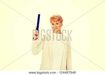 Smile elderly woman pointing up with hege pen