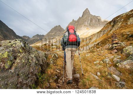 A young woman is hiking on the mountains