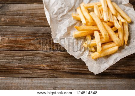 French fries on wooden table. Top view.