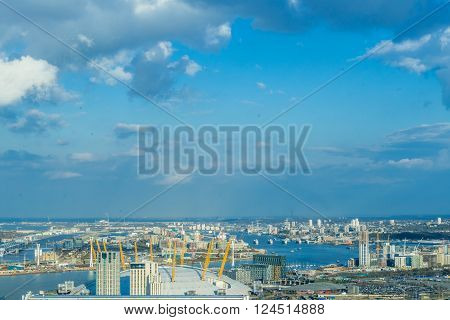 London United Kingdom - March 31 2016: View at London O2 Arena North Greenwich Thames Barriers various residential building and new construction sites. View from Canary Wharf office buildings