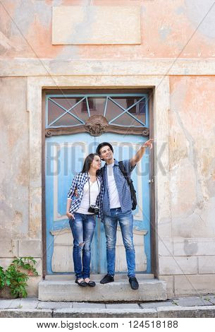 Young couple traveling and exploring new places. Traveling and couchsurfing concept.