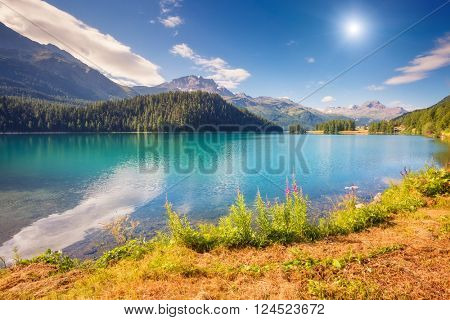 Fantastic view of the azure pond Champfer. Picturesque scene. Location: resort Silvaplana village, district of Maloja in the Swiss canton of Graubunden, Alps. Europe. Artistic picture. Beauty world.