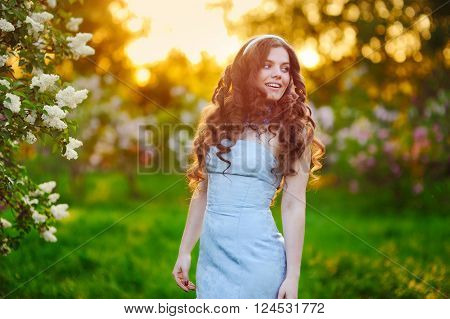 tiful young girl, shot against setting sun