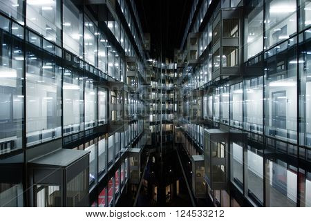 Beautiful illuminated windows of modern building at night in city