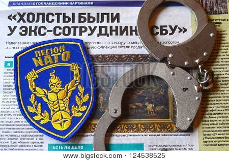 Kiev,Ukraine.FEB 20.ILLUSTRATIVE EDITORIAL.Chevron Ukrainian nazionalist battalion.Background - newspaper about West Frisian Museum stolen art . February 20,2016 in Kiev, Ukraine