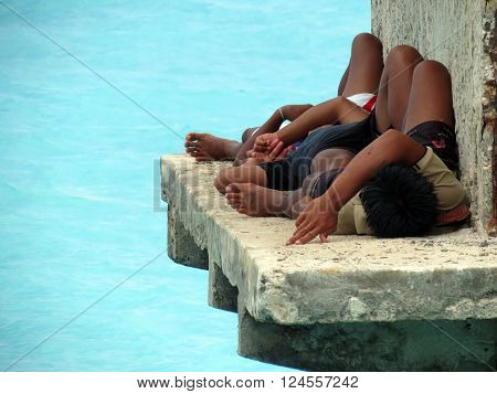 Andaman-Apr 14: Three tired andamanese fishermen resting at a jetty Apr 14, 2012 in Andaman and Nicobar Island, India, Asia.