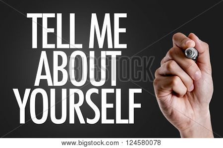 Hand writing the text: Tell Me About Yourself
