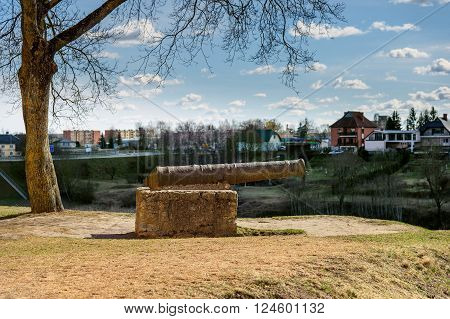 Old iron cannon on a pedestal in Bauska town, Latvia