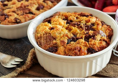 Bread pudding in a white ramekin close up view