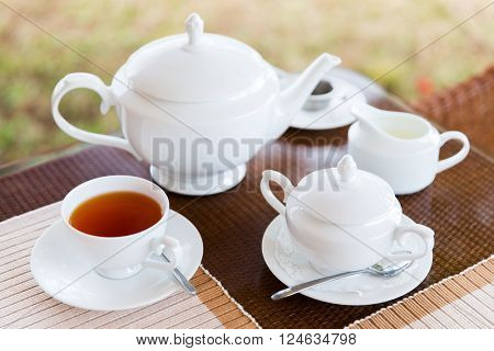 teatime, drink and object concept - close up of tea service on table at restaurant or teahouse
