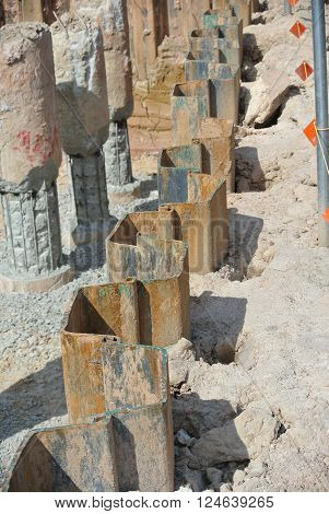 MALACCA, MALAYSIA -SEPTEMBER 25, 2015: Temporary steel sheet retaining wall using sheet pile cofferdam method holding outside soil from collapse into pile pits.