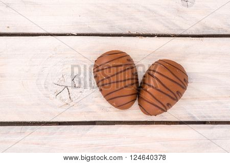 Chocolate Eggs On A Wooden Table