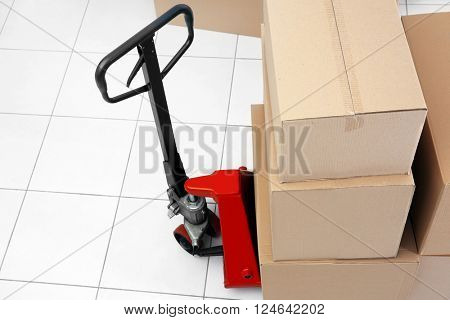 Manual pallet truck with carton boxes indoors