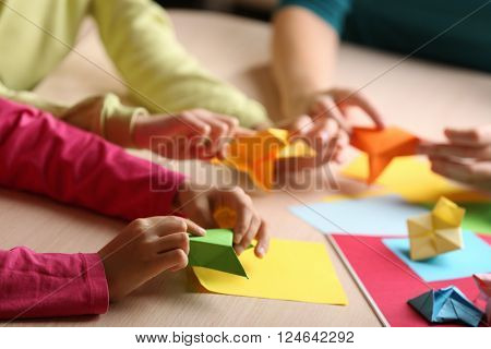 Children making swan with coloured paper
