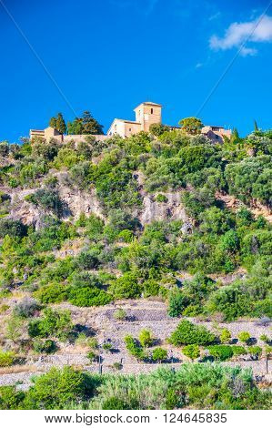 Beautiful view of a small mountain village Deia in Mallorca, Spain. Houses built on hills in Deia mountain village in Majorca island, Spain.