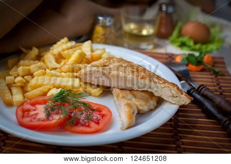 Chop and fries with tomatoes on the plate