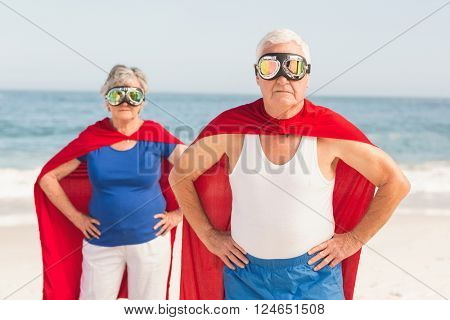Senior coiple wearing superman costume on a sunny day