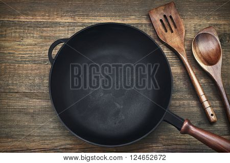 Empty Clean Cast Iron Frying Pan On Wooden Background