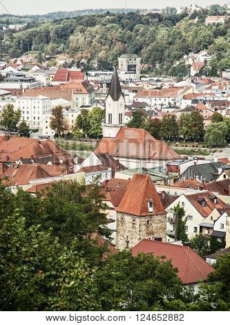 Roofs in Passau city with church tower. Architectural scene in Germany. Vertical composition.