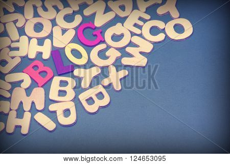 Blog Colored Sign Among Different Uncolored Letters On Green Background Top View Close Up